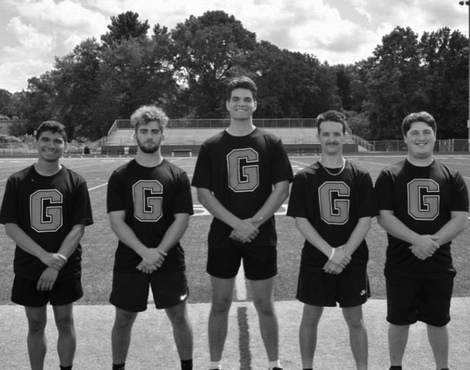The 2025 male cheerleaders posing together during media day.