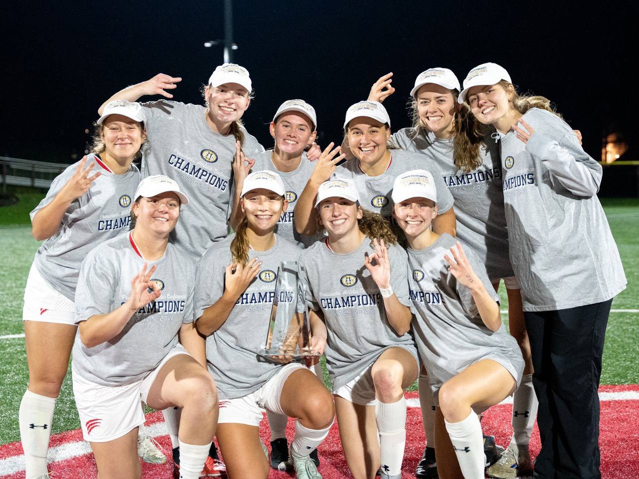 BOTTOM: The women’s soccer seniors, enjoying their three-peat.