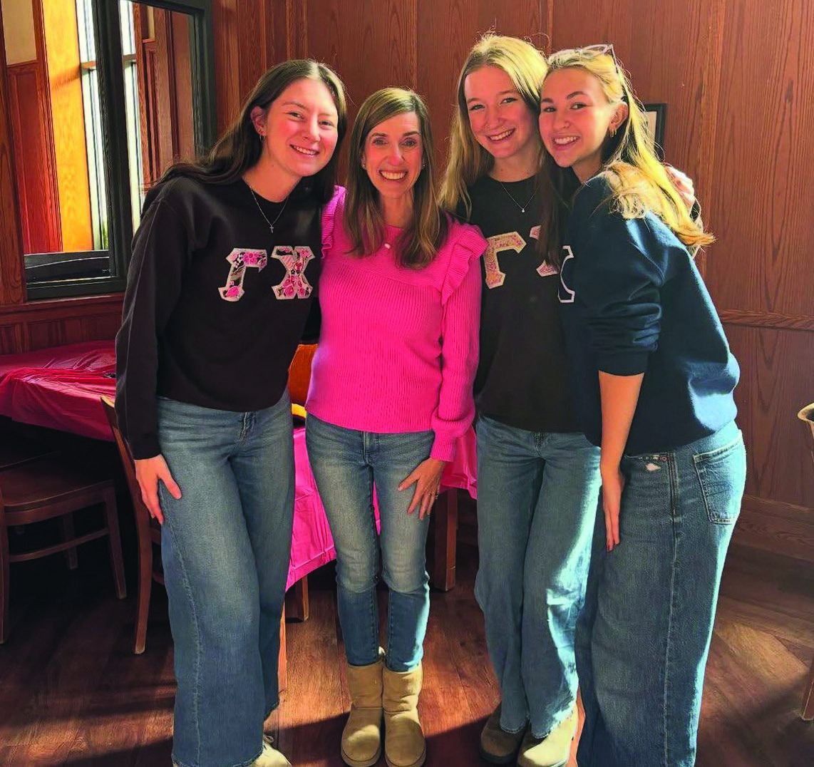 Bottom: Lingo meets with Gamma Chi girls for pumpkin carving.