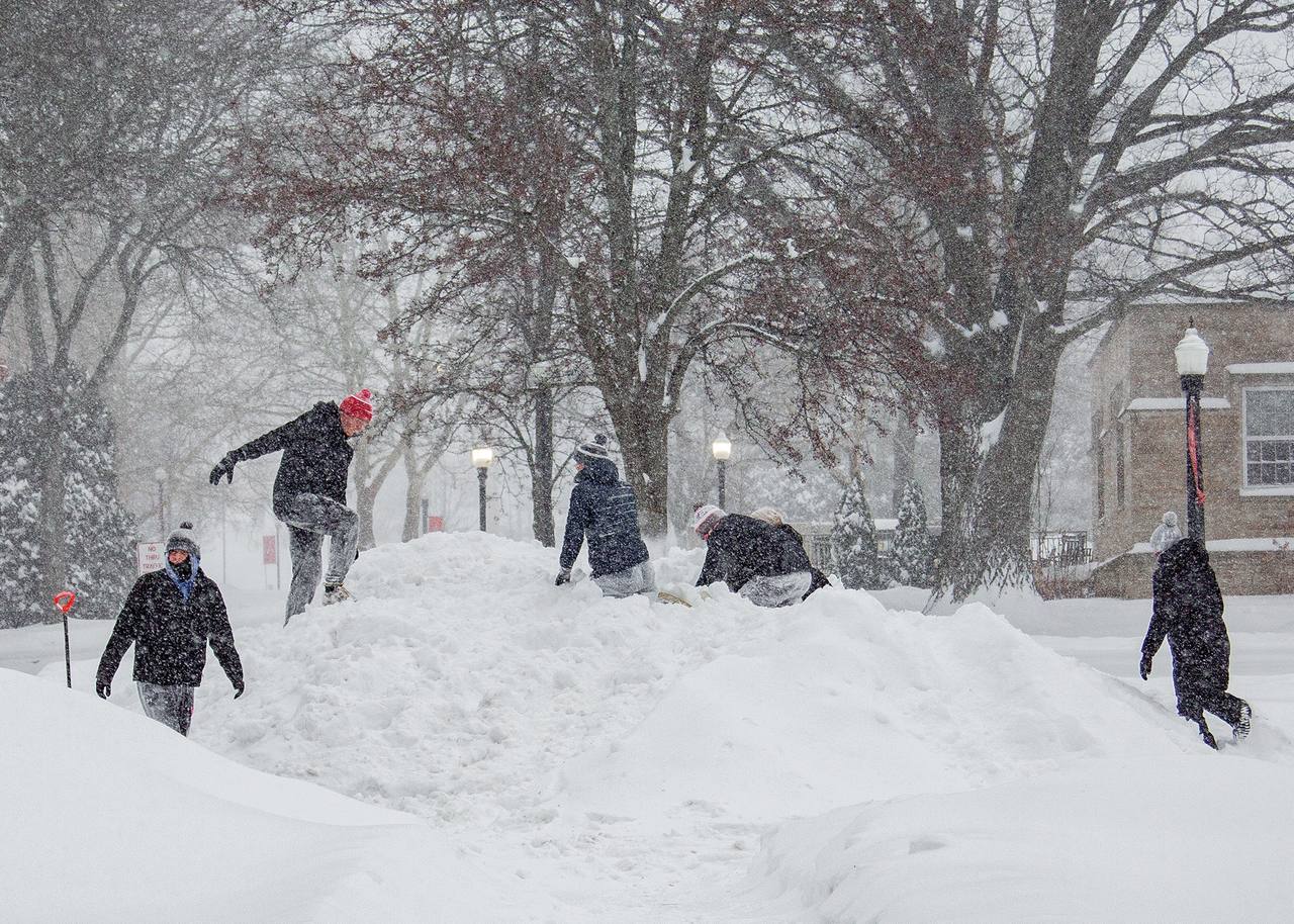 Students enjoy snow on the cul-de-sac on Campus Drive Sunday.